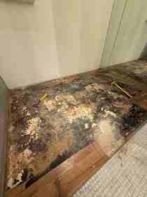 Old commercial flooring torn out with a hammer and pry bar.