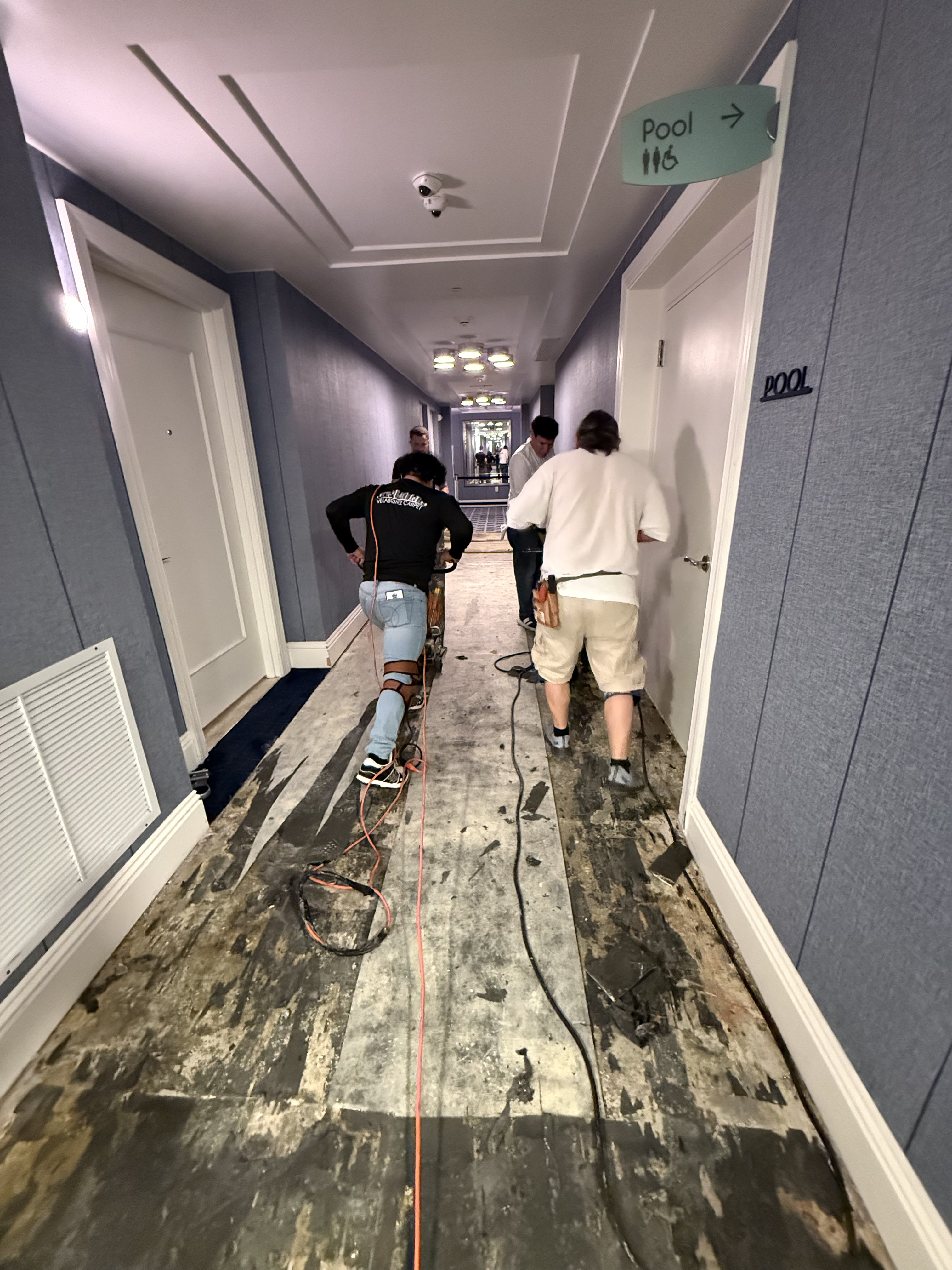 Hotel corridor with pool sign during carpet repair Hotel corridor with a pool sign while the flooded carpet is opened up for repair