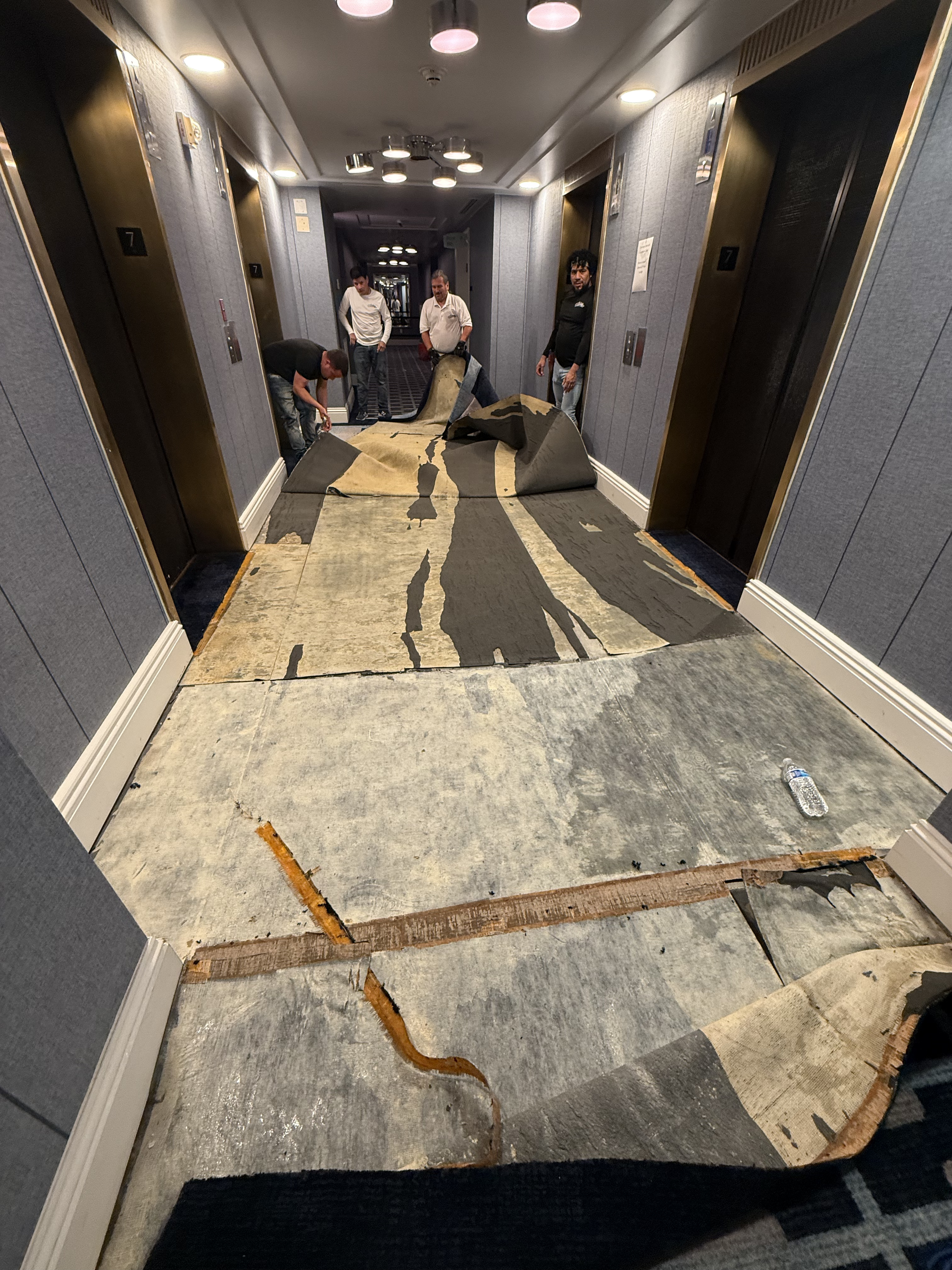 Padding and subfloor exposed near the hotel elevators during carpet repair