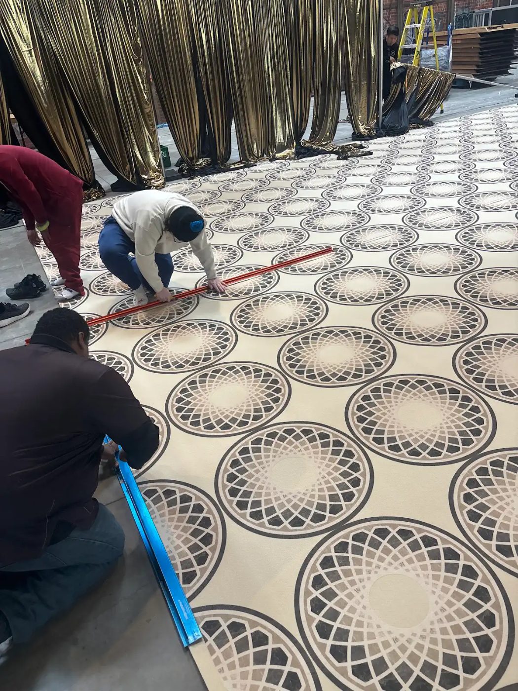 Custom printed medallion pattern event carpet being installed in Miami