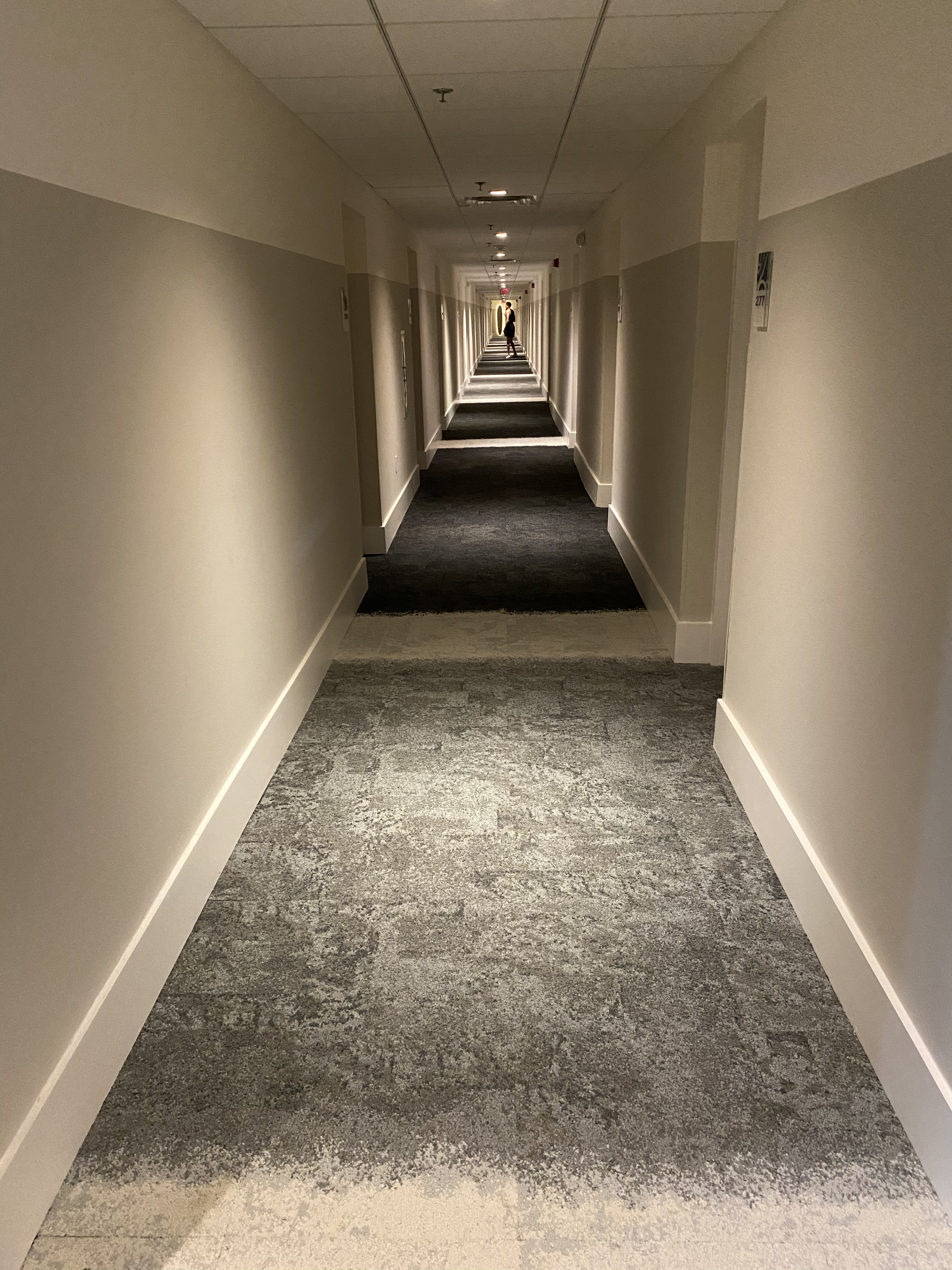 Finished commercial carpet in a long hotel guest corridor
